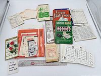 Overview of all score pads, cards, loose sheets and ruler for scale