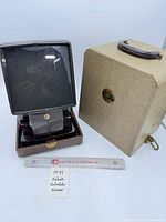 Viewer with screen extended beside carrying case, ruler for scale