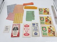 Overall lot layout showing all stamp sheets, saver books and vouchers