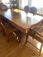 table top with scalloped corner, chairs partly visible