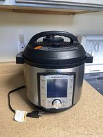Front view of Instant Pot showing control panel and power cord