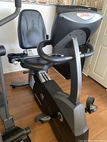 Front and side view of Life Fitness R3 recumbent bike showing seat, console, pedals