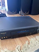 Front view of Panasonic PV-4564 VCR showing tape door and branding