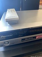 Front view of Pioneer DVR-450H-S with remote on top