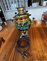 Full view of brass samovar with cord attached