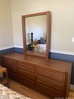 Front view of teak veneer dresser with attached mirror