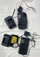 Complete kit laid out: two receivers with AC adapters, two transmitters, battery visible