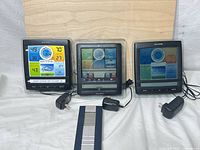 Front view of all three AcuRite weather station consoles with adapters
