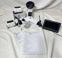 Full kit laid out: sensor array, two remote sensors, display console, mounting hardware, manuals