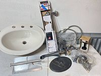 Sink, boxed shower rod, assorted faucet parts