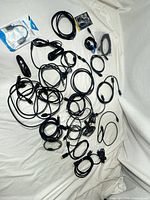 Overview of all coiled black cables spread on surface