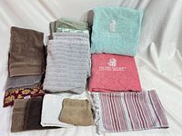 All 12 towels laid out showing variety of colors, sizes and patterns