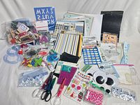 Overview of entire lot showing papers, stickers, googly eyes, scissors, punches, ribbon, gems, envelopes, cutting templates