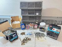 All items grouped including organizer, boxes of nails, staples jar, turnbuckles, loose fasteners