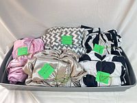 Tray with five bundled king bedding sets showing colors and patterns