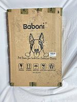 Front of Baboni pet door box with dog graphic and product details, visible staining and tape