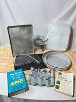 Group shot of all bakeware items, carrier, cookbooks