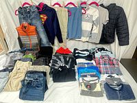 Full lot displayed on table and hangers showing variety of clothing pieces