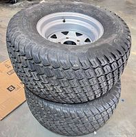 Both tires stacked showing tread and rims