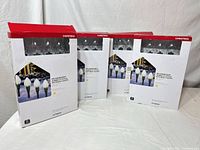 Four retail boxes of At Home incandescent jumbo C7 pathway Christmas lights