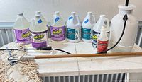 Overview of all gallon jugs, pump sprayer and mop