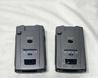 Top view of both Escort Solo S2 detectors showing branding and cosmetic wear