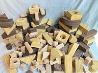 Pile of assorted foam blocks in various wood-tone finishes and shapes