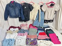 Full lot overview showing hanging garments and folded items