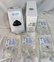 Dispenser, cardboard box and four refill cartridges displayed