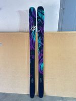 Full front view of both skis showing length and overall condition