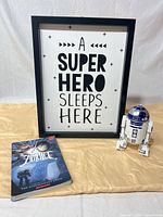 Entire lot: framed print, R2-D2 toy, Amulet book