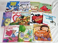 All 13 children’s books laid out face-up showing titles, formats and cover condition