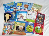 All 13 children’s paperback picture books laid out cover-up for title visibility