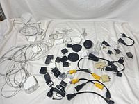 Overview of all chargers, adapters, cables spread on sheet
