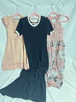 Three dresses hanging front view
