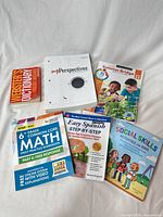 All six books laid out on white backdrop showing covers