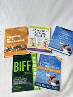 Five books laid out on white backdrop