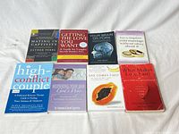 Eight paperback books laid out showing covers