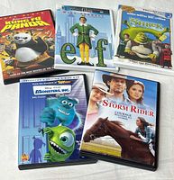 Front view of five DVD cases: Kung Fu Panda, Elf, Shrek, Monsters Inc., Storm Rider