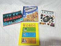 Four of the five hardcover children’s reference books laid out