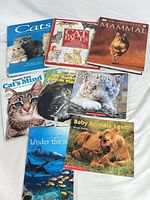 All eight hardcover books laid out showing covers