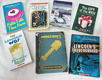 All eight books laid out showing front covers