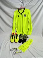 Full kit layout showing jersey, cleats, shin guards, socks