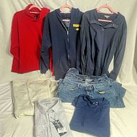 Group shot of all clothing items folded or hung