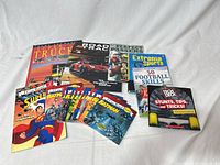 Group shot of all 18 books showing sports/auto titles, Superman and Batman readers