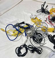 Pile of mixed Ethernet and phone cables various colors