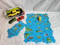 Full lot showing boxed RC Camaro, two loose cars, foam mat pieces assembled and bus