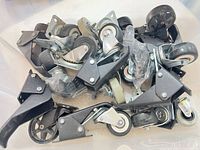 Bin containing assorted swivel casters showing variety of wheel sizes, materials and mounts