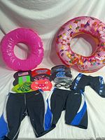 Full lot showing two inflatable rings, swim caps, goggles, and four swimsuits