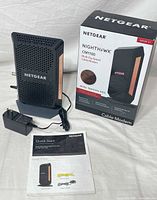 Modem, power adapter, manual, box grouped together